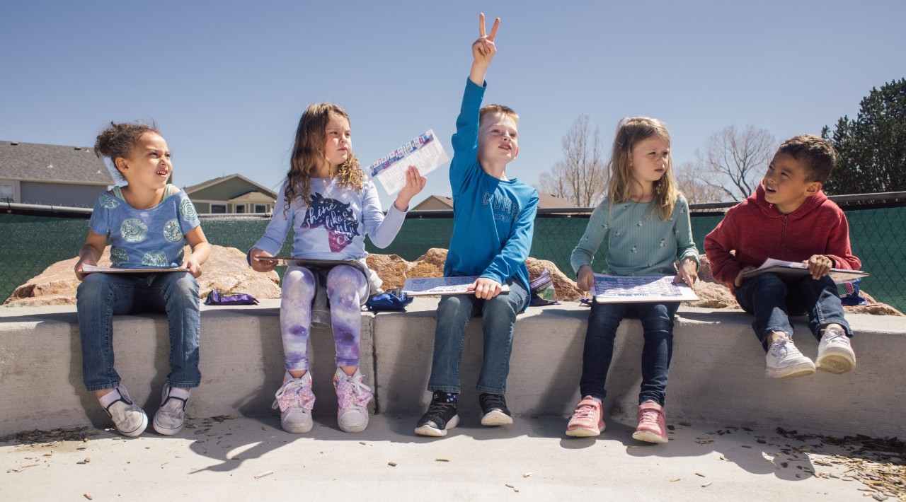 Pioneer students sit outside during an outdoor class.